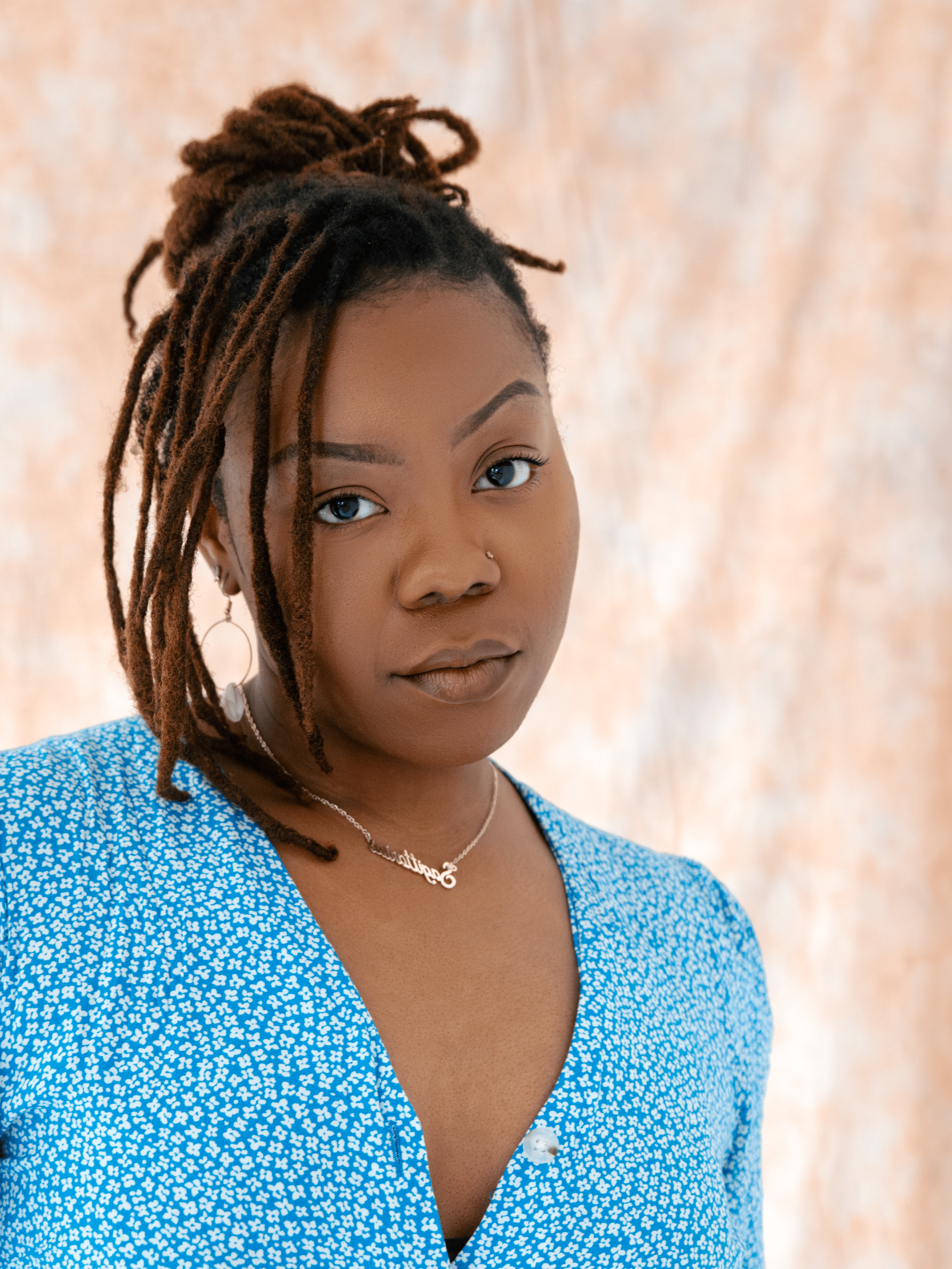 Ewa Dina, London-based director, actor & facilitator. Professional headshot in neutral tones.