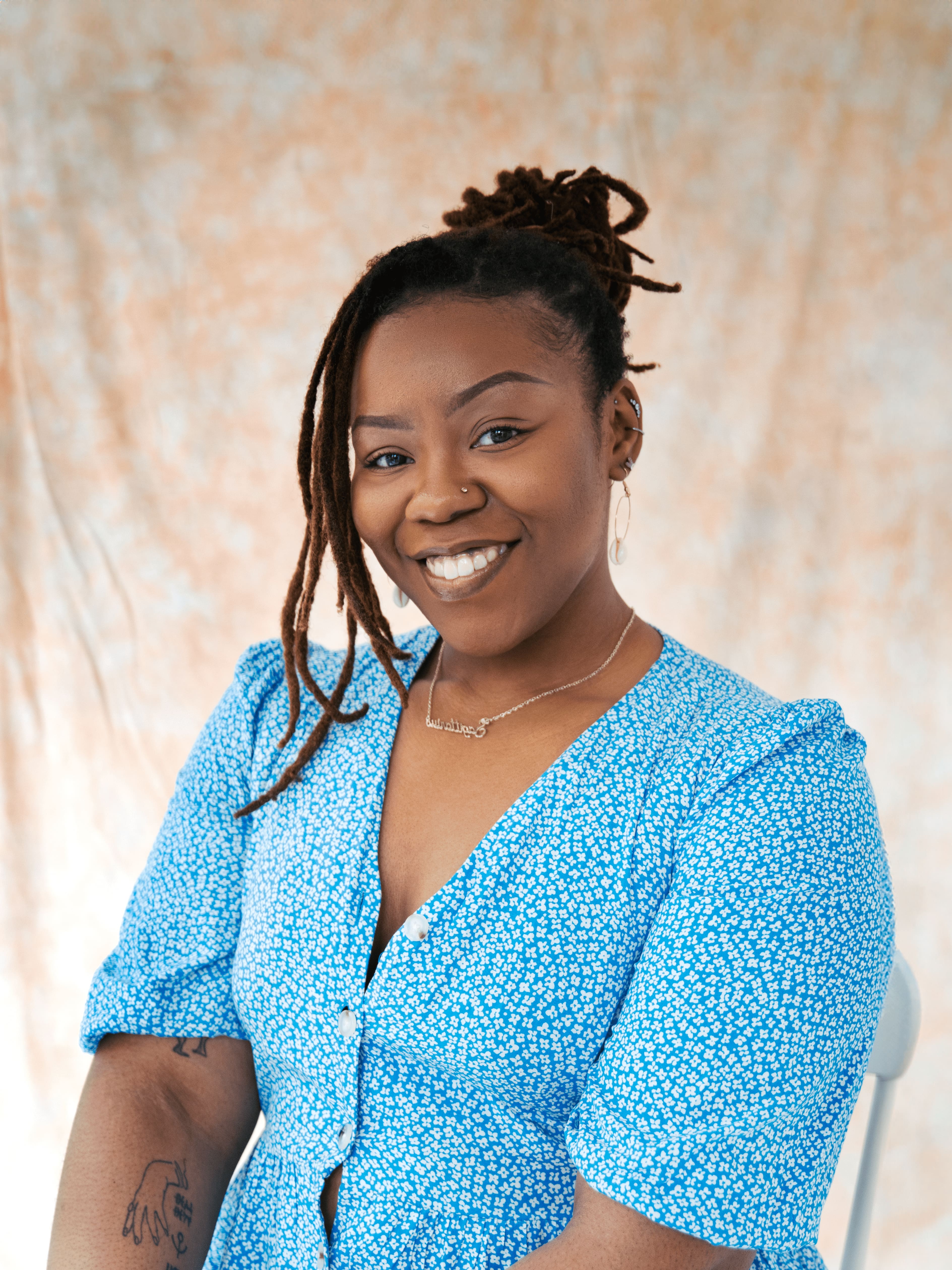 Ewa Dina, London-based director, actor & facilitator. Professional headshot in neutral tones.2